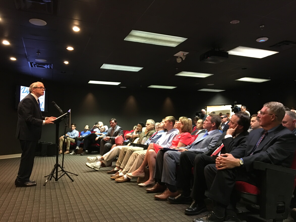 Ohio Chamber of Commerce president Andy Doehrel (far right), Ohio Business Roundtable president Pat Tiberi and running mate Jon Husted watch as Republican candidate for governor Mike DeWine unveils his workforce development plan. 